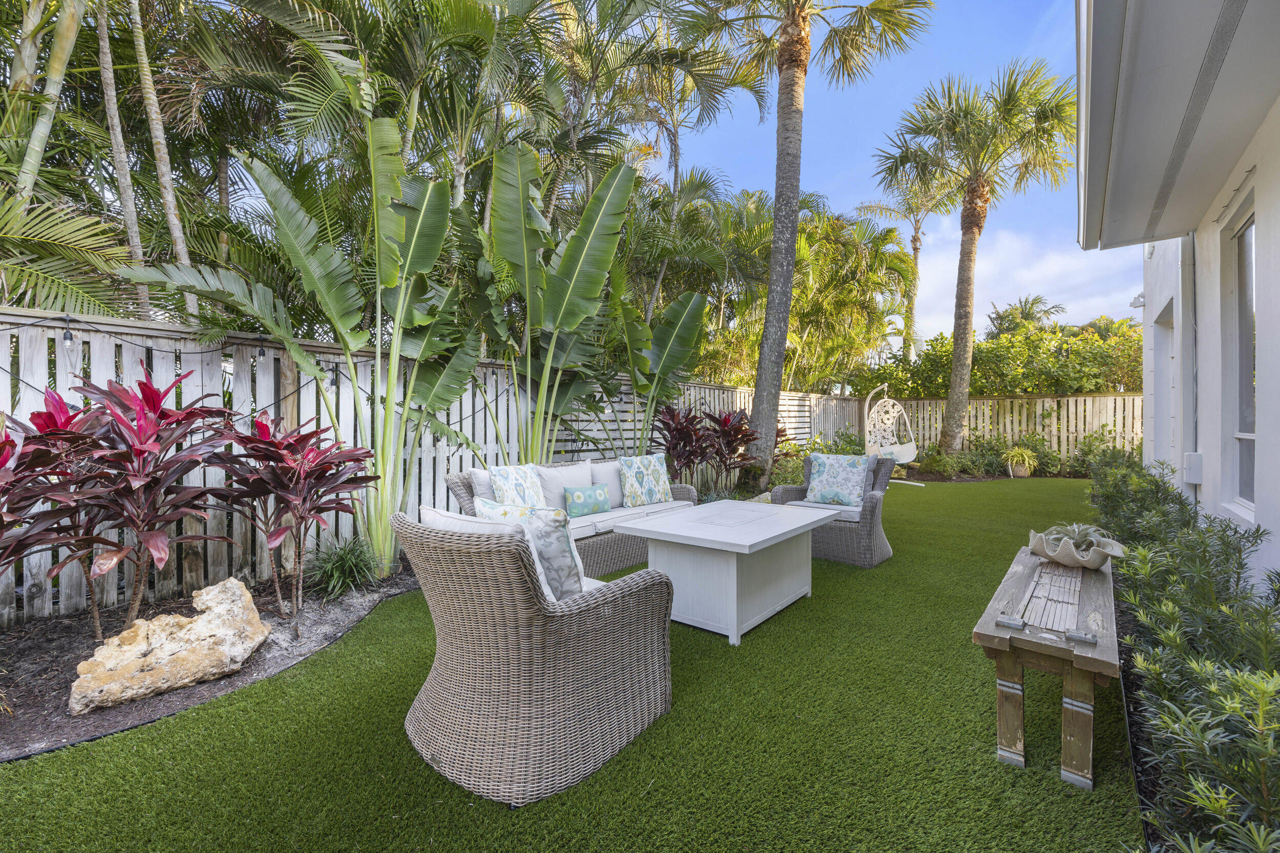 122 Lighthouse Drive Jupiter Inlet Colony, FL 33469 - Photo 48 of 84 a view of a chair and table in backyard of the house