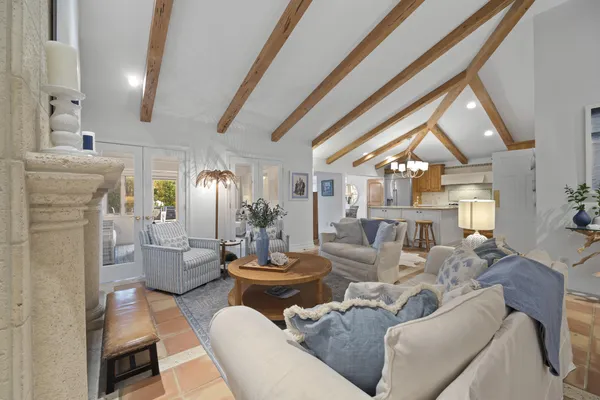 a living room with furniture and a chandelier
