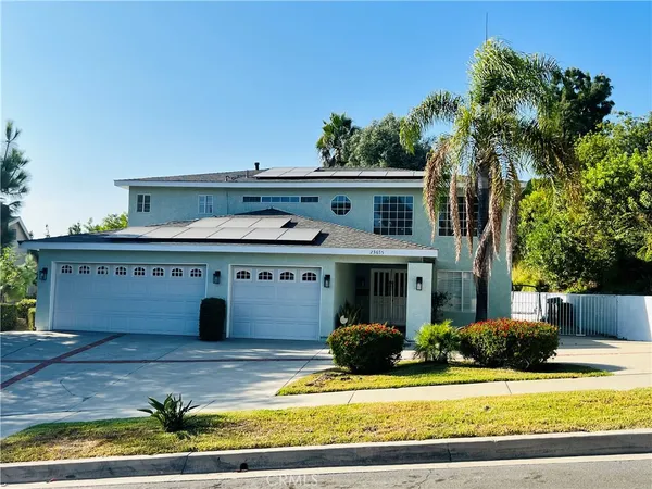 a view of house with yard and swimming pool