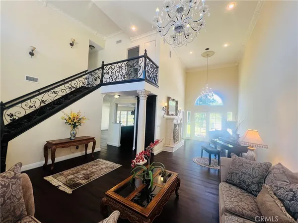a living room with furniture and a chandelier