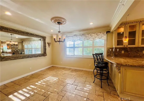 a view of a kitchen with granite countertop lots of counter top space and dining table