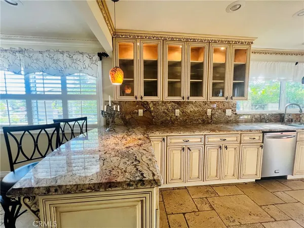 a view of a kitchen with granite countertop a sink and a stove
