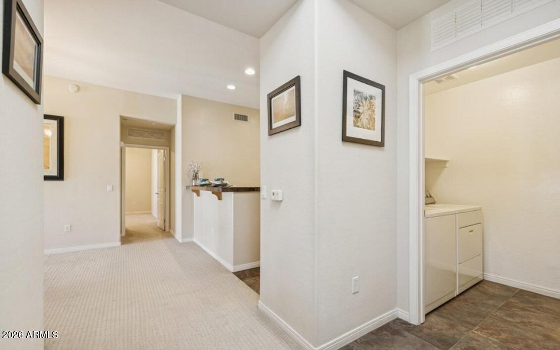 2989 North 44th Street, Unit 2023 Phoenix, AZ 85018 - Photo 11 of 20 a view of a hallway with closet and wooden floor
