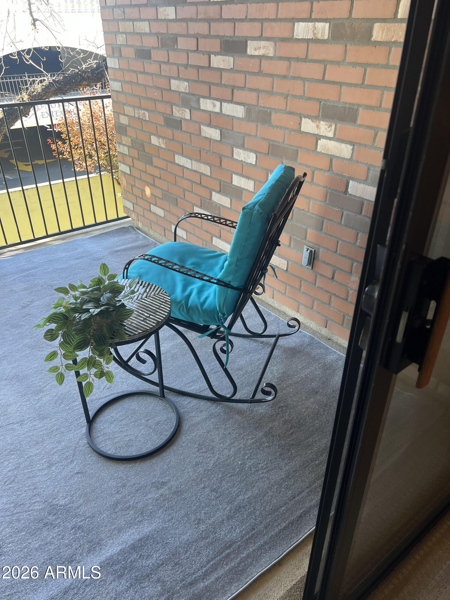2989 North 44th Street, Unit 2023 Phoenix, AZ 85018 - Photo 12 of 20 a view of balcony with chairs and wooden floor