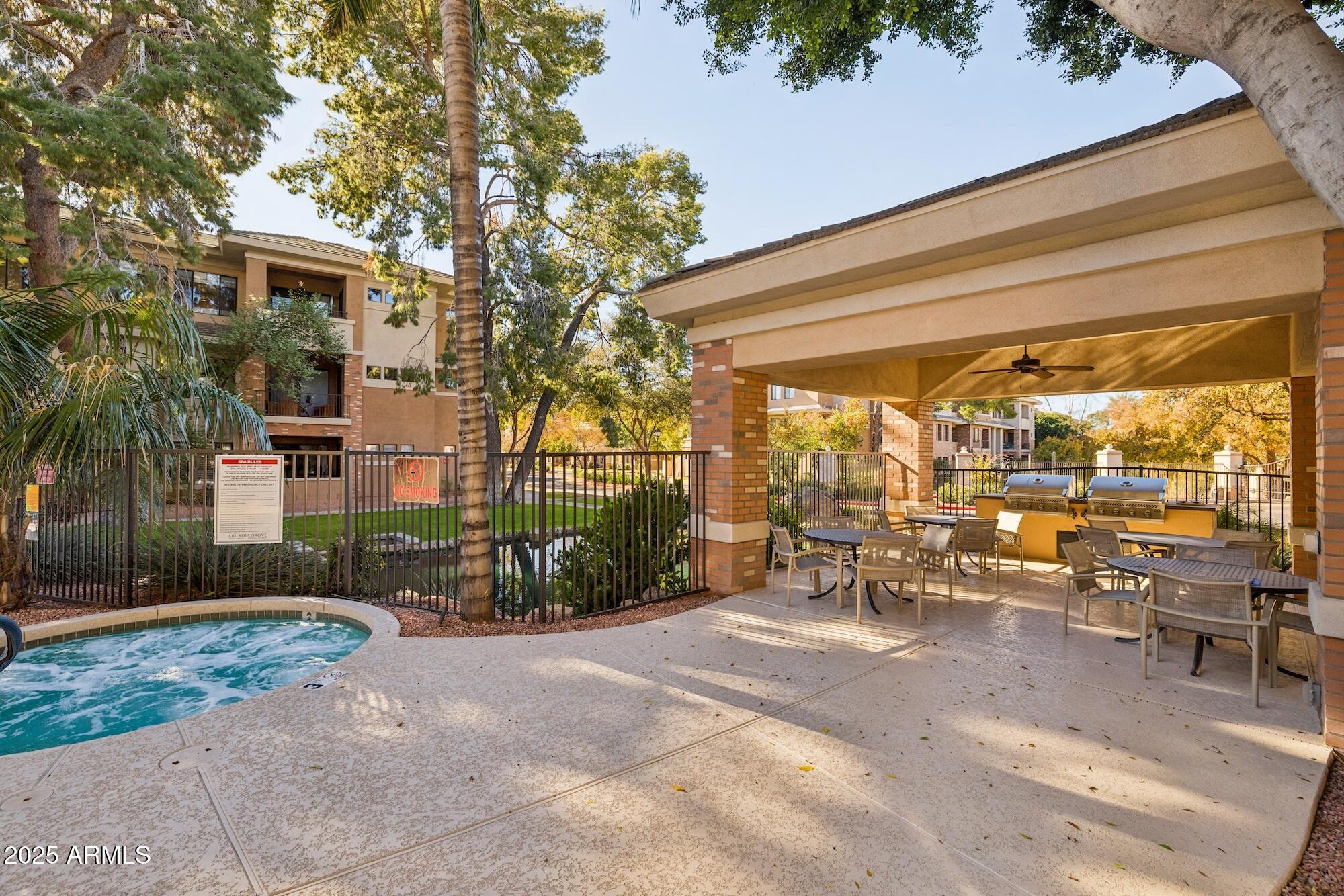2989 North 44th Street, Unit 2023 Phoenix, AZ 85018 - Photo 13 of 20 a view of a patio with table and chairs and potted plants