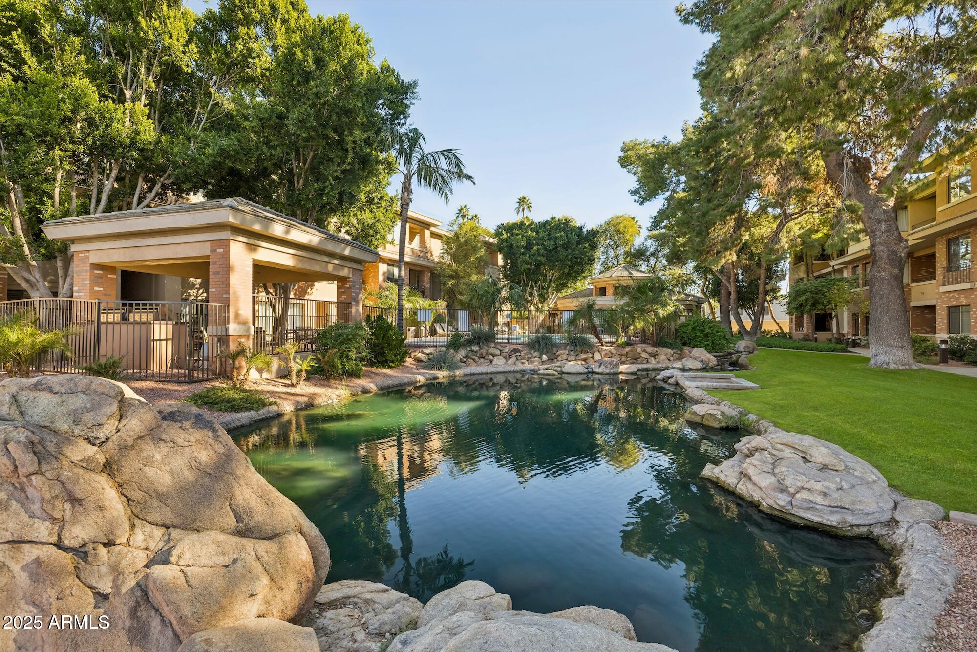 2989 North 44th Street, Unit 2023 Phoenix, AZ 85018 - Photo 15 of 20 a view of a lake with a house in the background