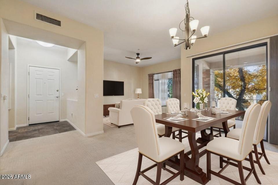 2989 North 44th Street, Unit 2023 Phoenix, AZ 85018 - Photo 3 of 20 a view of a dining room with furniture window and outside view