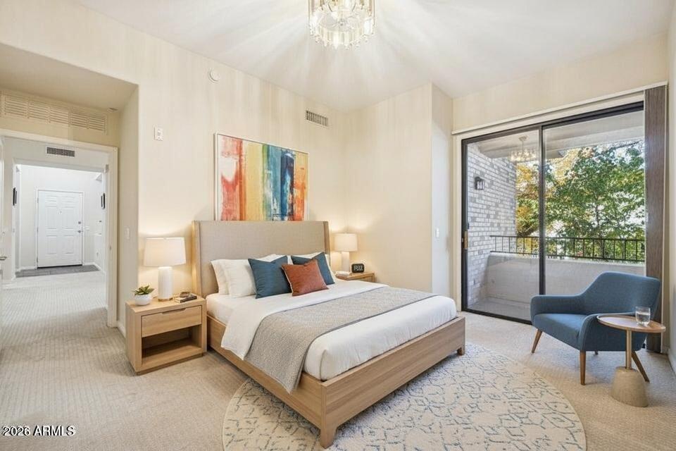 2989 North 44th Street, Unit 2023 Phoenix, AZ 85018 - Photo 4 of 20 a bedroom with a bed chair and window