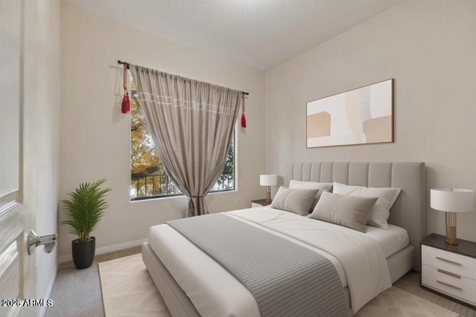 2989 North 44th Street, Unit 2023 Phoenix, AZ 85018 - Photo 7 of 20 a bedroom with a bed and a potted plant