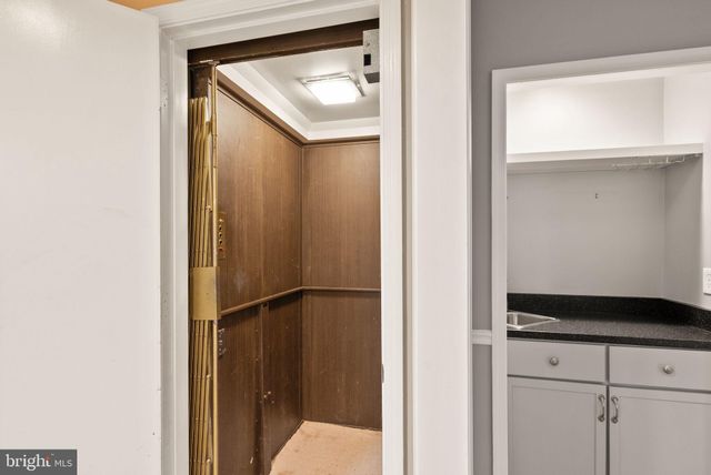 a view of a livingroom with a fireplace wooden floor and window