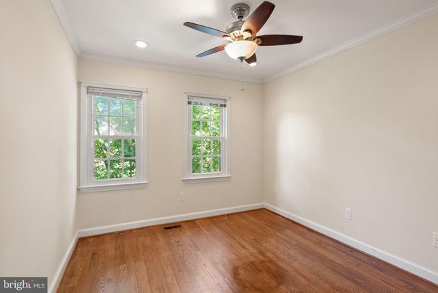 an empty room with wooden floor and sliding door