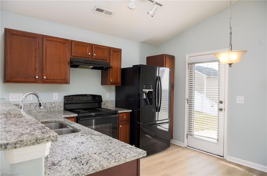 1150 Red Sage Road Winston-Salem, NC 27127 - Photo 3 of 21 Beautiful kitchen with granite counters, eat in breakfast nook, and black appliances