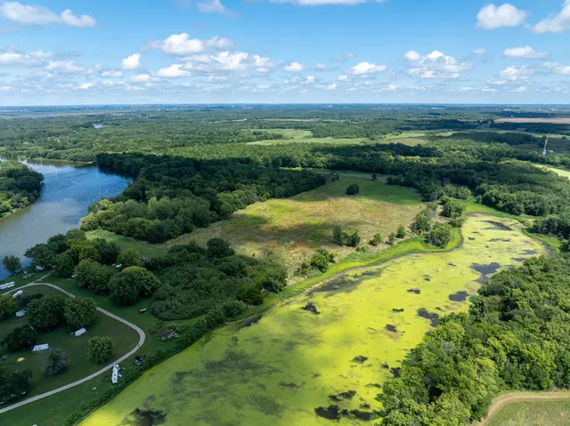 a view of a lake with a yard in the background