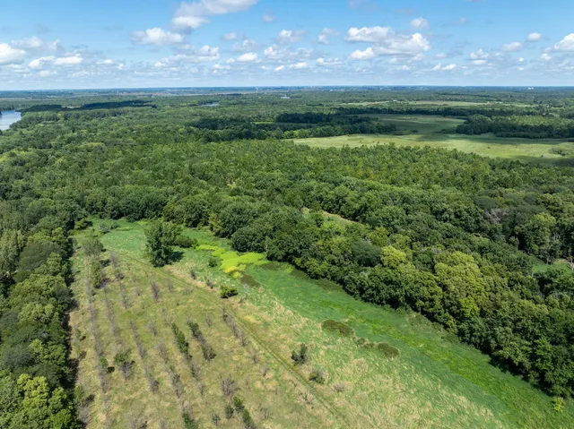 a view of a green field with lots of green space in the background