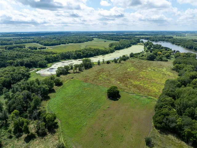 an aerial view of residential houses with outdoor space and trees