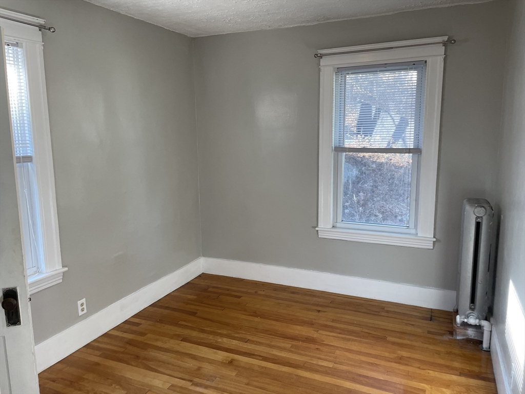 82 Brantwood Road, Unit 2 Worcester, MA 01602 - Photo 12 of 15 a view of empty room with wooden floor and fan