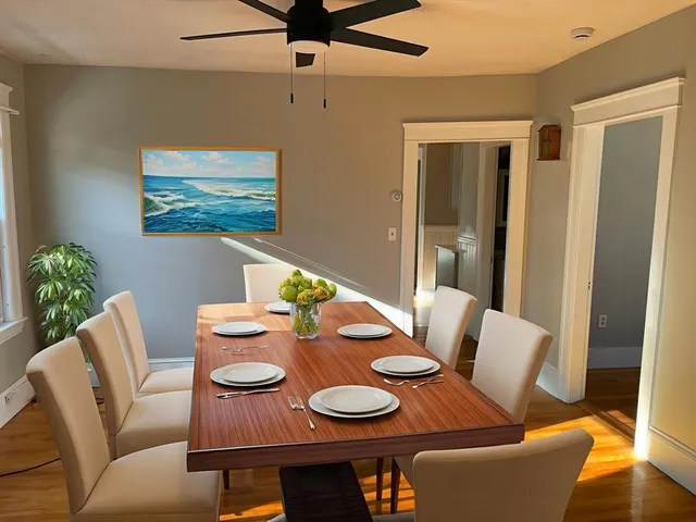 a view of a dining room with furniture and wooden floor