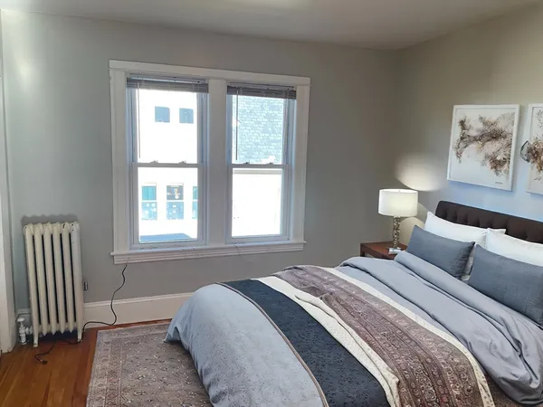 a bedroom with a bed and a window