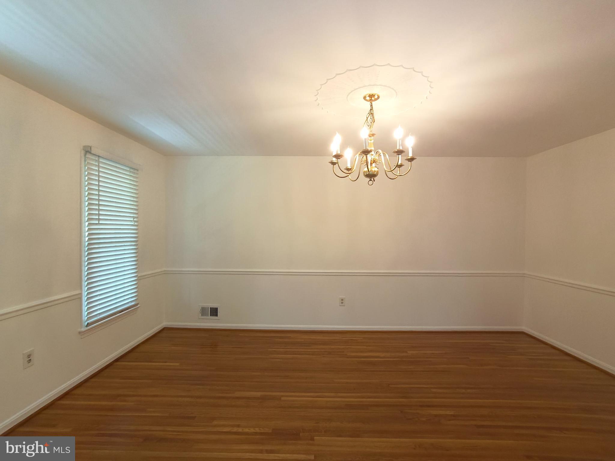 8835 Tuckerman Lane Potomac, MD 20854 - Photo 12 of 46 wooden floor in an empty room with a window
