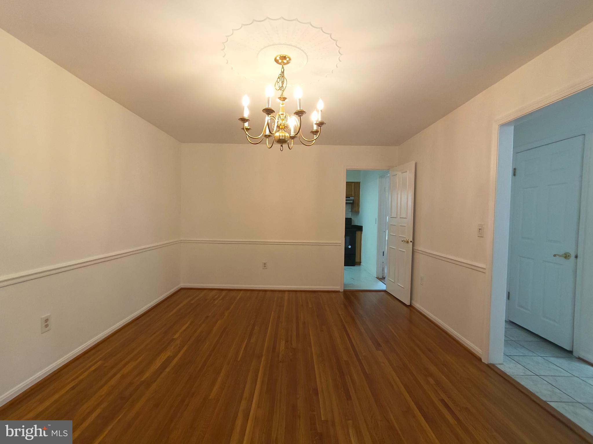 8835 Tuckerman Lane Potomac, MD 20854 - Photo 15 of 46 wooden floor in an empty room with a window