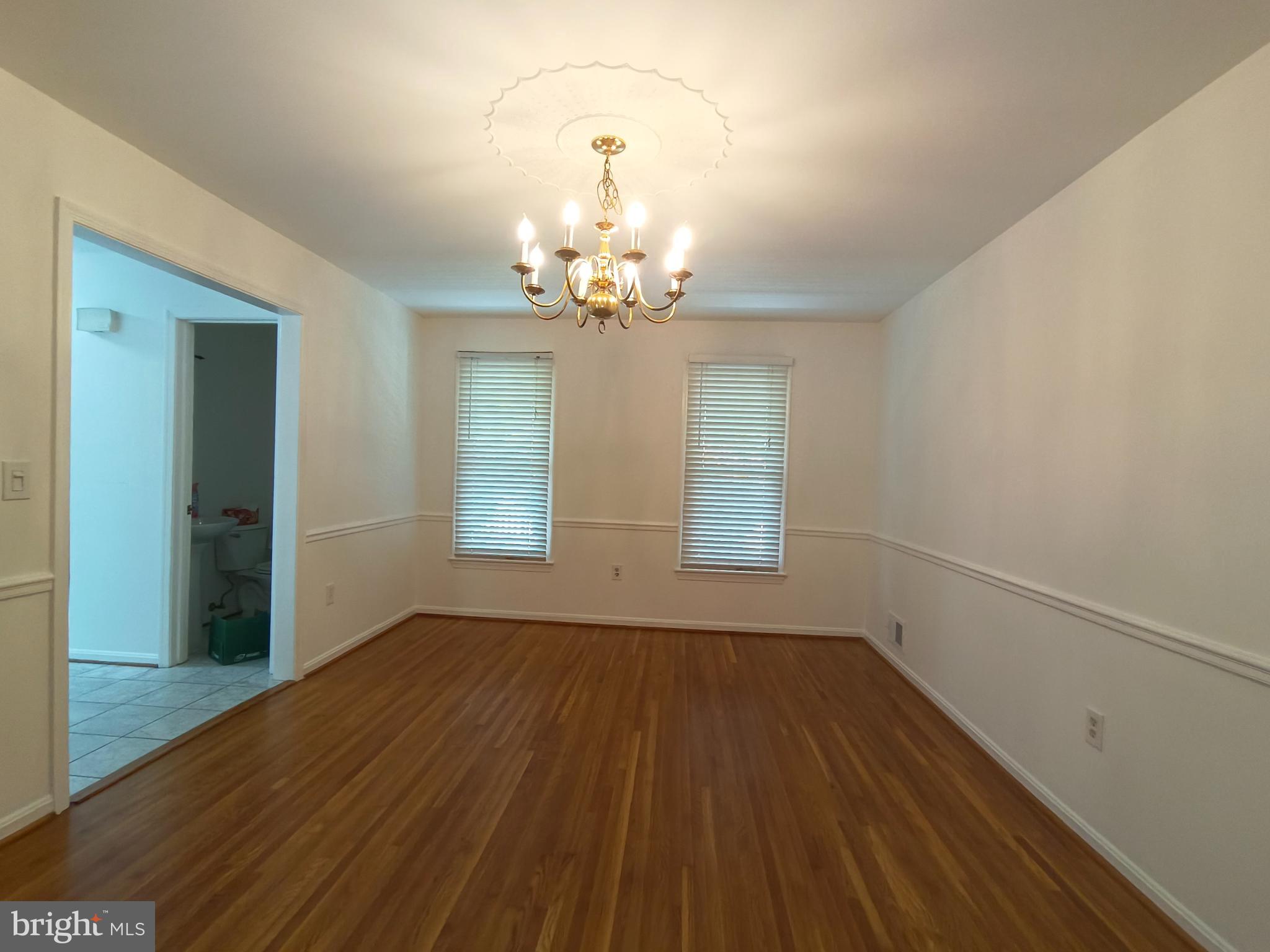 8835 Tuckerman Lane Potomac, MD 20854 - Photo 16 of 46 wooden floor in an empty room with a window