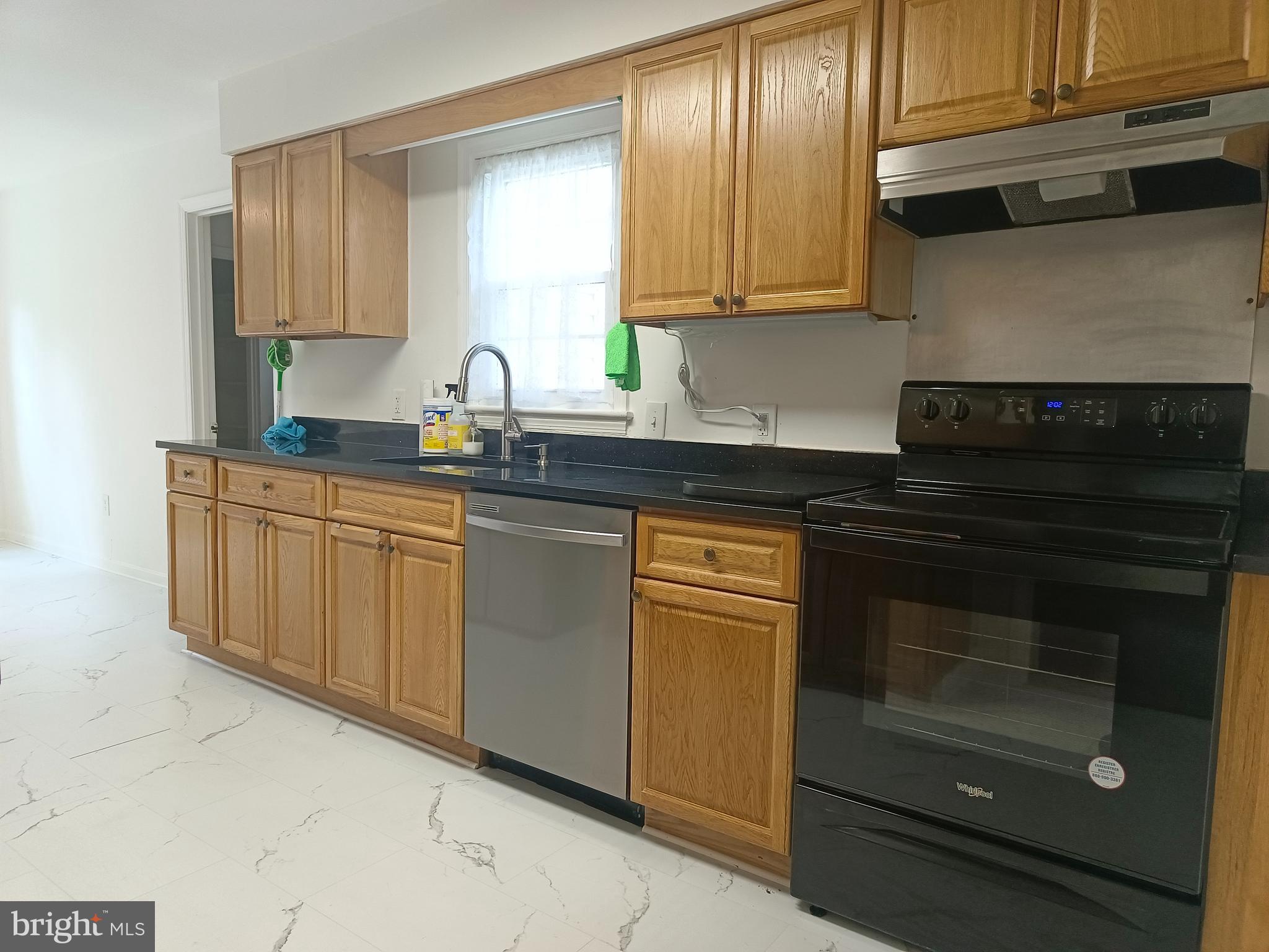 8835 Tuckerman Lane Potomac, MD 20854 - Photo 18 of 46 a kitchen with granite countertop white cabinets and stainless steel appliances