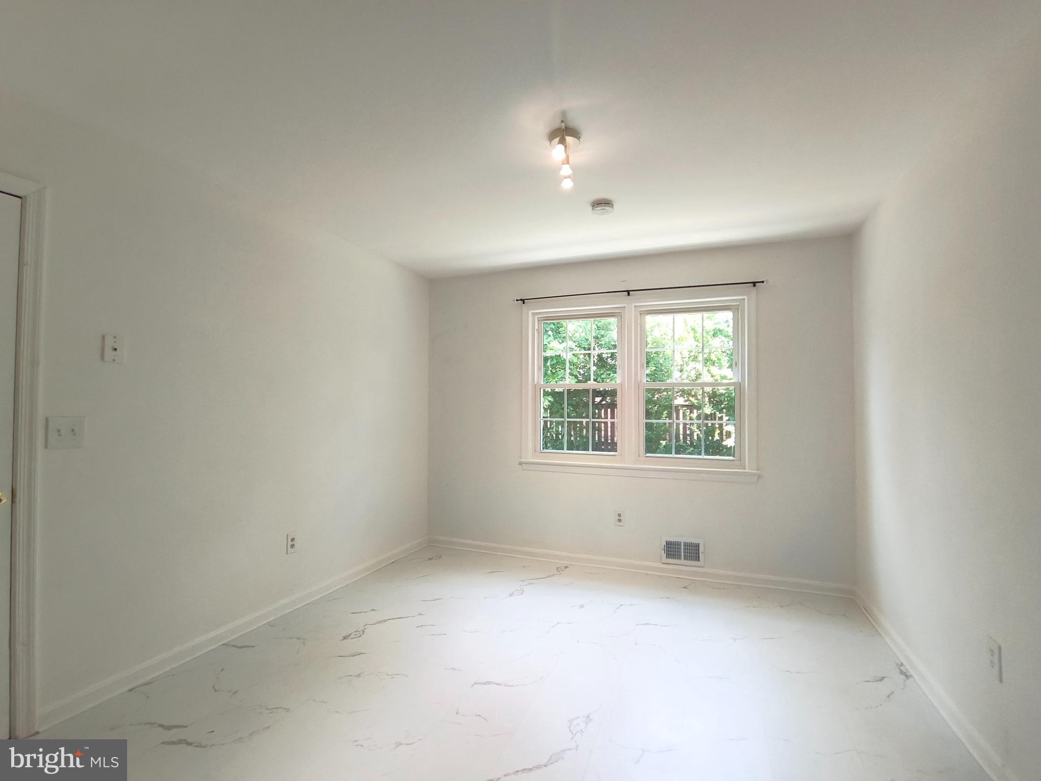 8835 Tuckerman Lane Potomac, MD 20854 - Photo 20 of 46 an empty room with windows