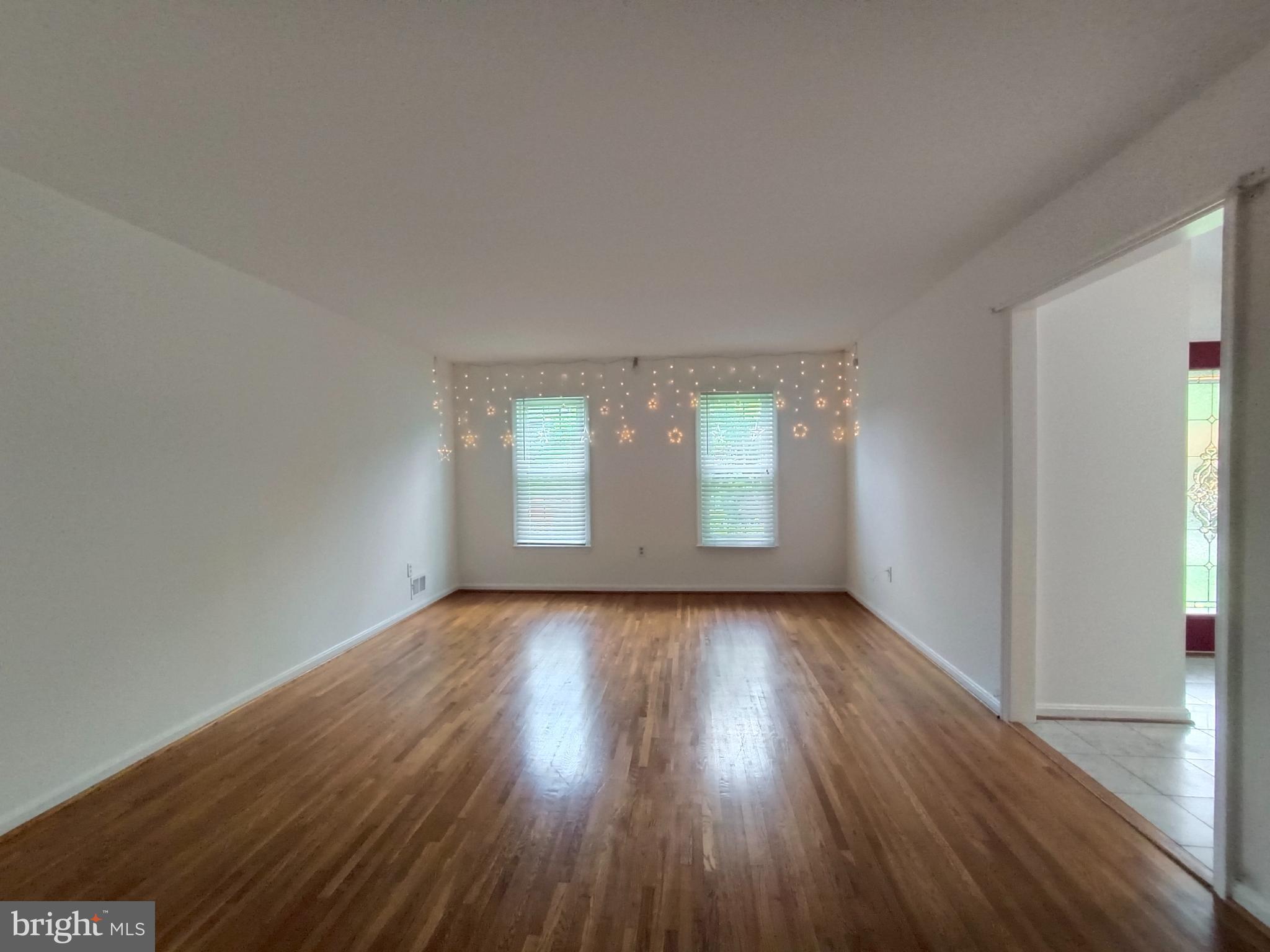8835 Tuckerman Lane Potomac, MD 20854 - Photo 2 of 46 an empty room with wooden floor and windows
