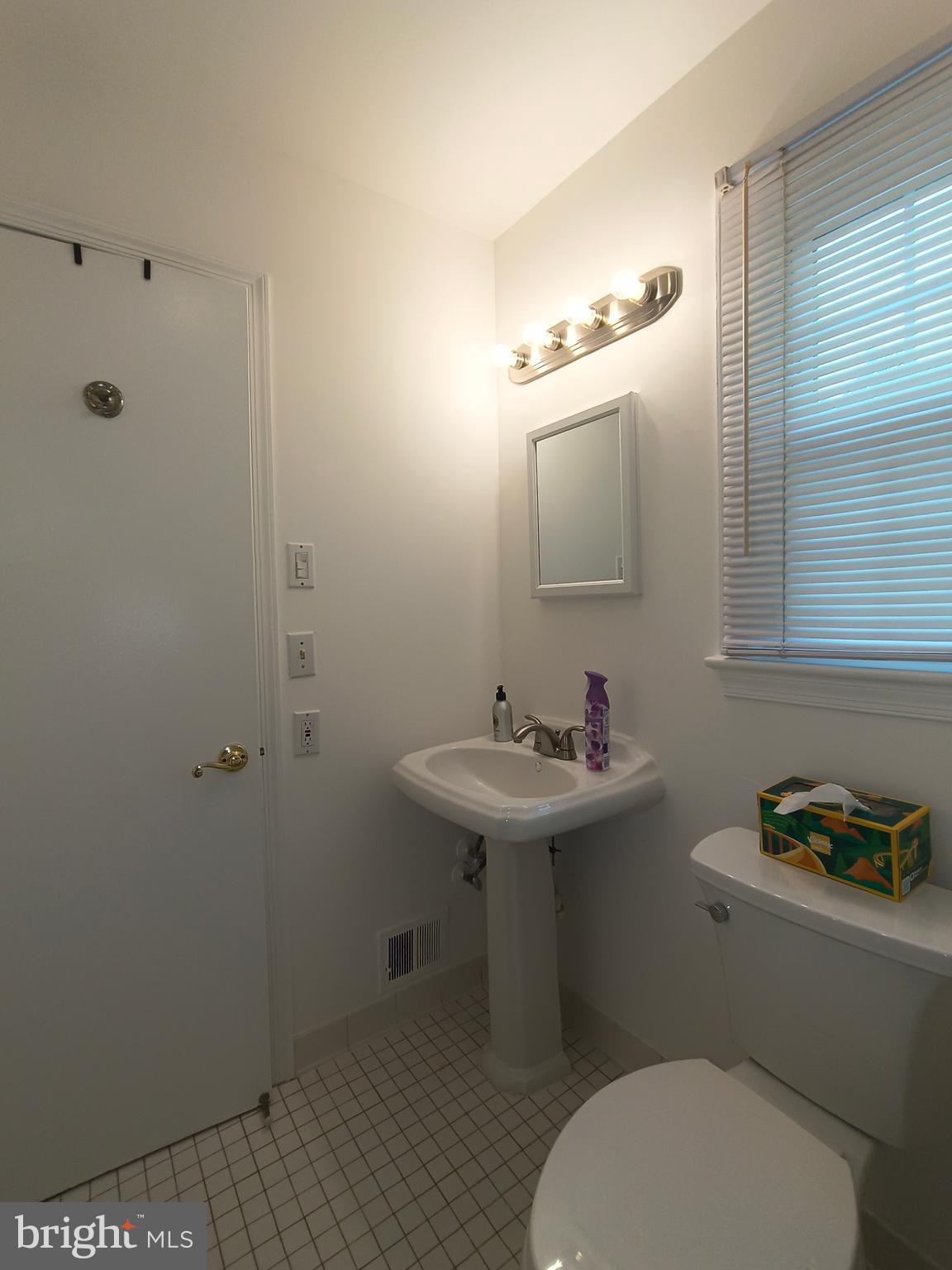8835 Tuckerman Lane Potomac, MD 20854 - Photo 23 of 46 a bathroom with a sink toilet and a mirror
