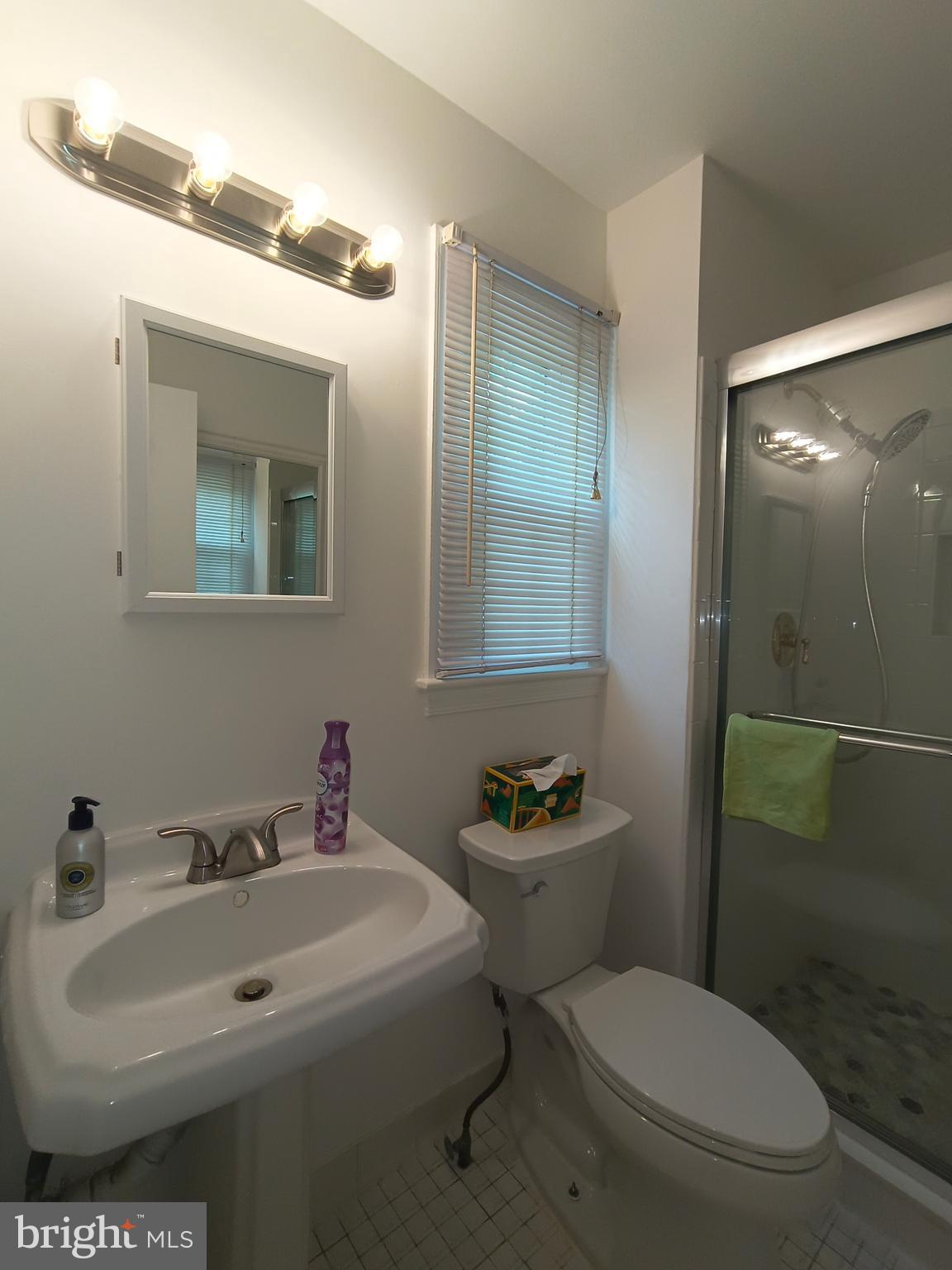 8835 Tuckerman Lane Potomac, MD 20854 - Photo 24 of 46 a bathroom with a toilet sink and mirror