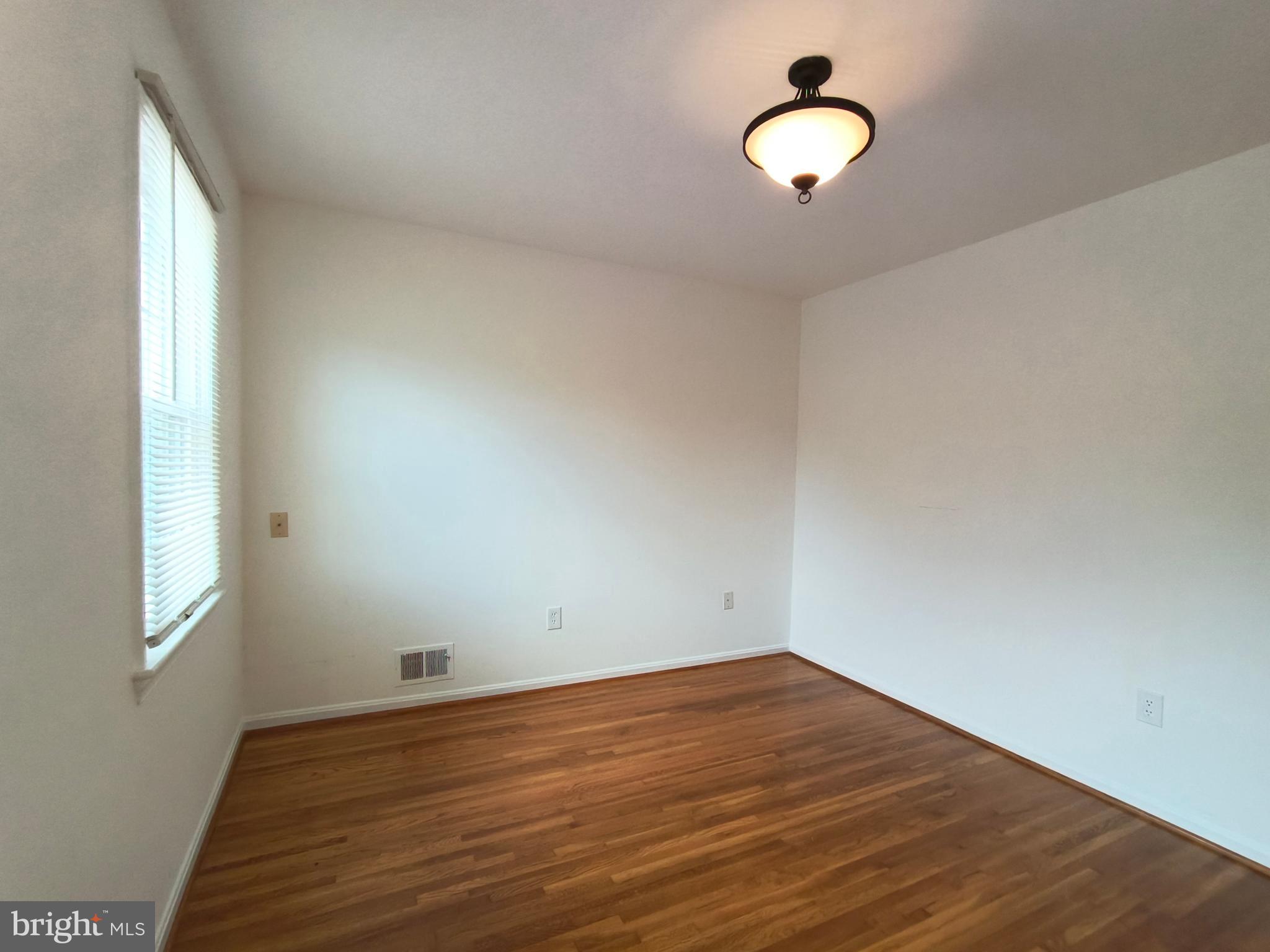 8835 Tuckerman Lane Potomac, MD 20854 - Photo 28 of 46 a view of a room with wooden floor and window