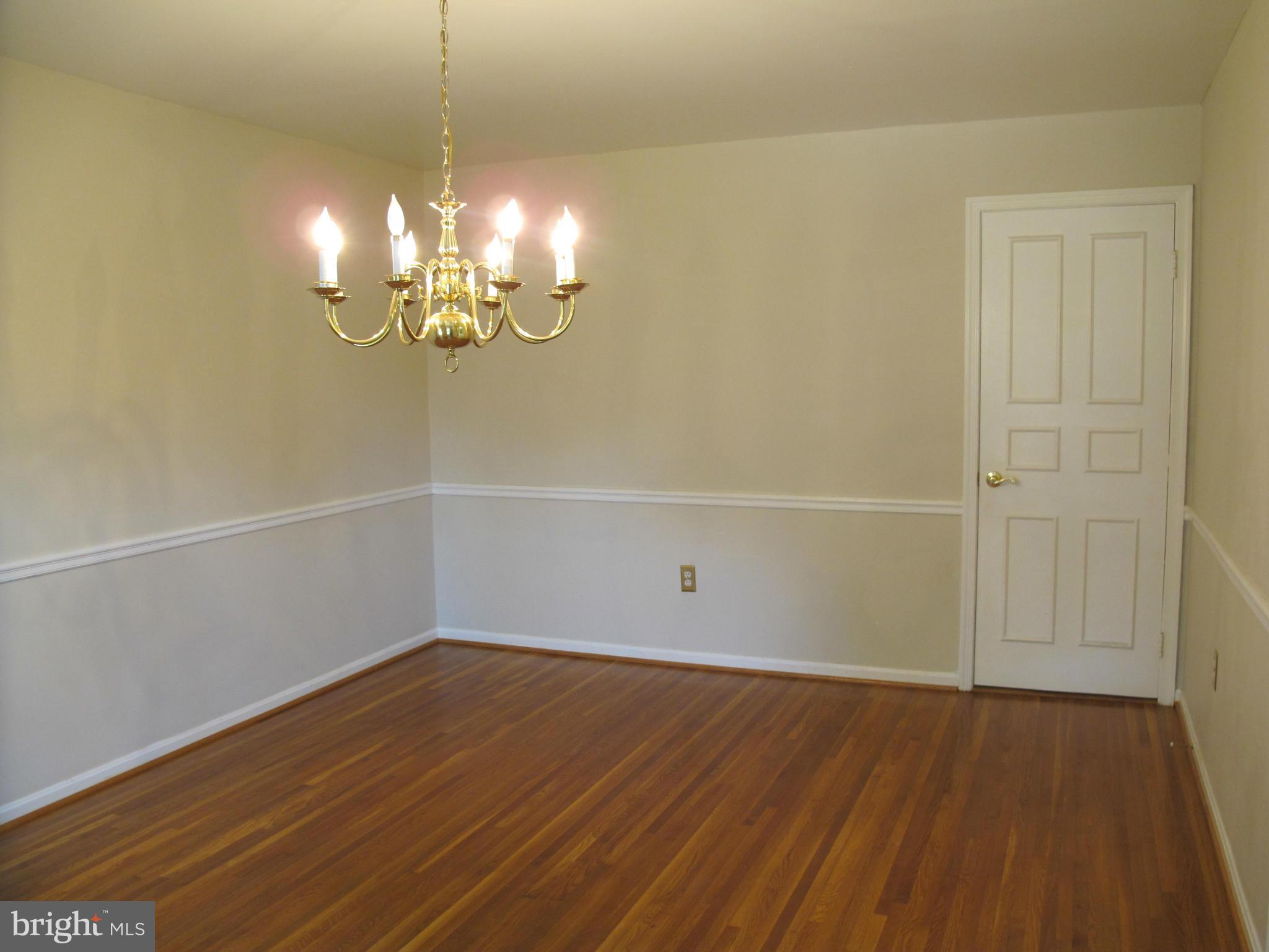 8835 Tuckerman Lane Potomac, MD 20854 - Photo 3 of 46 a view of a room with wooden floor and chandelier