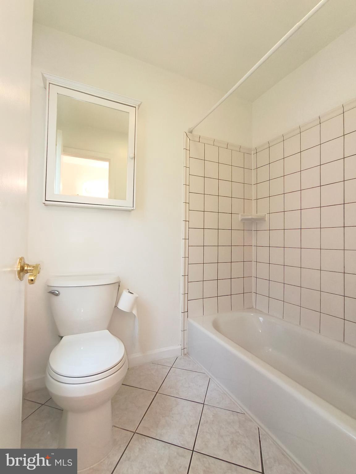 8835 Tuckerman Lane Potomac, MD 20854 - Photo 35 of 46 a bathroom with a toilet and bathtub