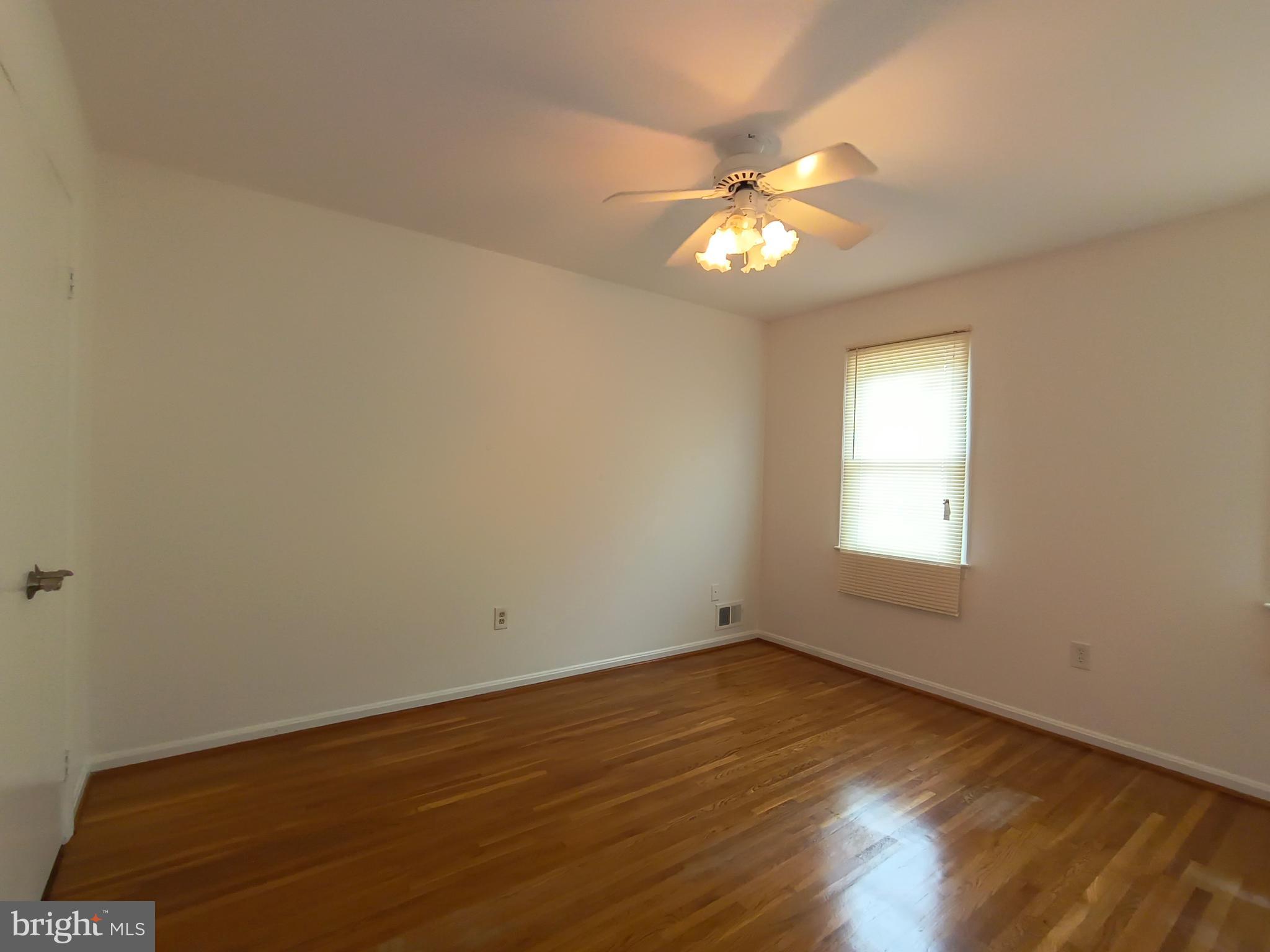 8835 Tuckerman Lane Potomac, MD 20854 - Photo 36 of 46 wooden floor in an empty room with a window