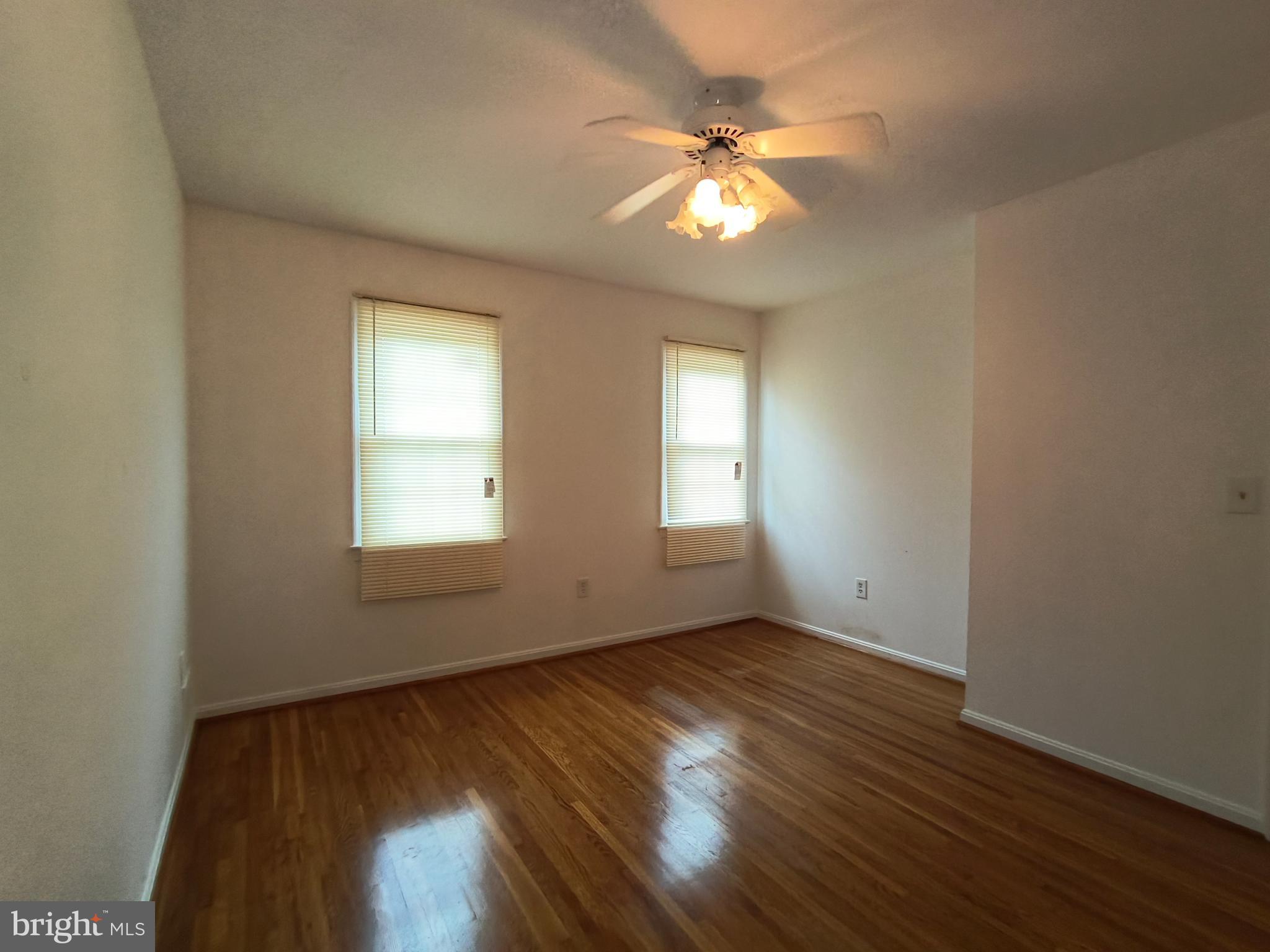 8835 Tuckerman Lane Potomac, MD 20854 - Photo 37 of 46 a view of an empty room with wooden floor and a window