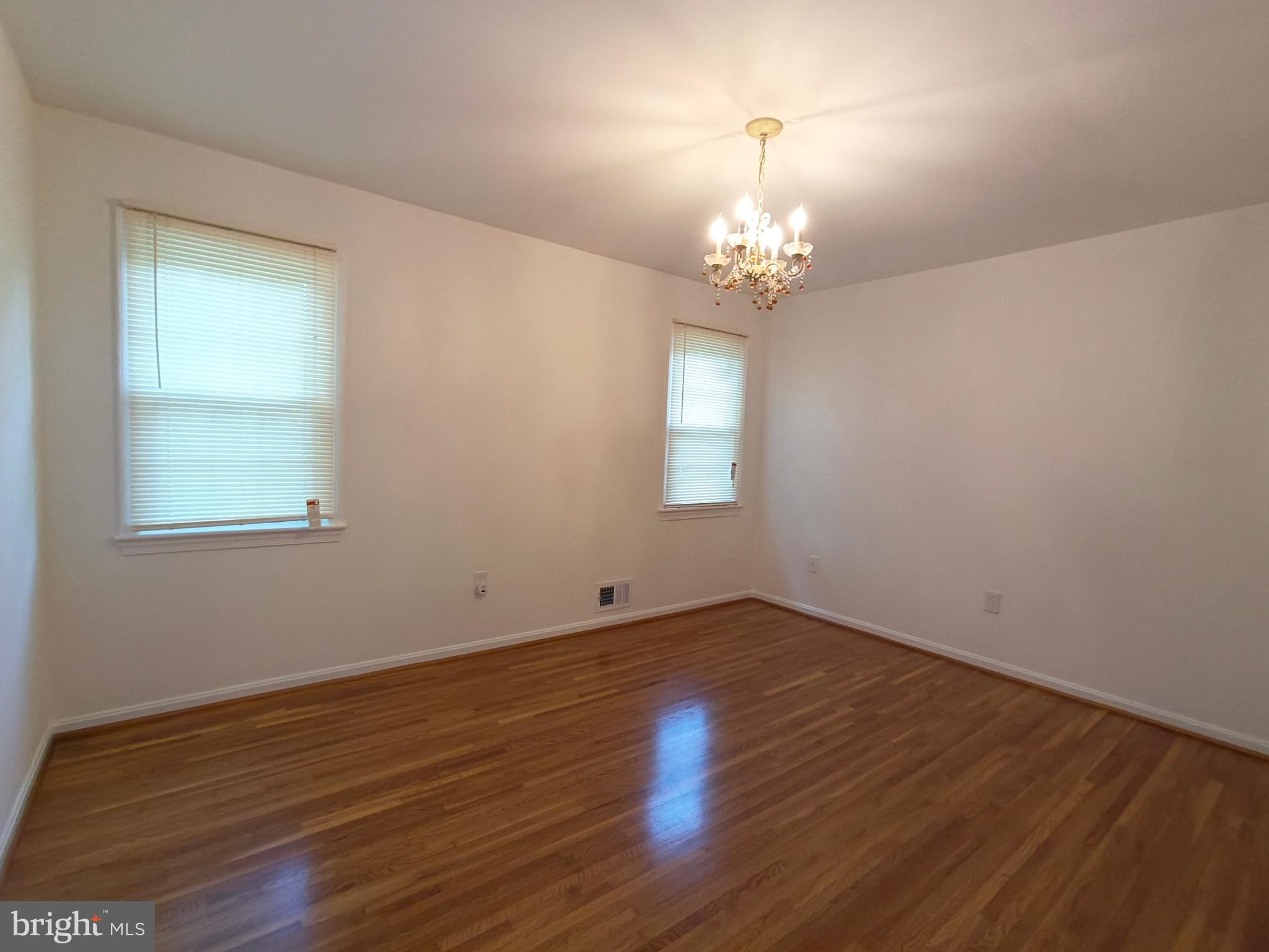 8835 Tuckerman Lane Potomac, MD 20854 - Photo 38 of 46 a view of an empty room with wooden floor and a window