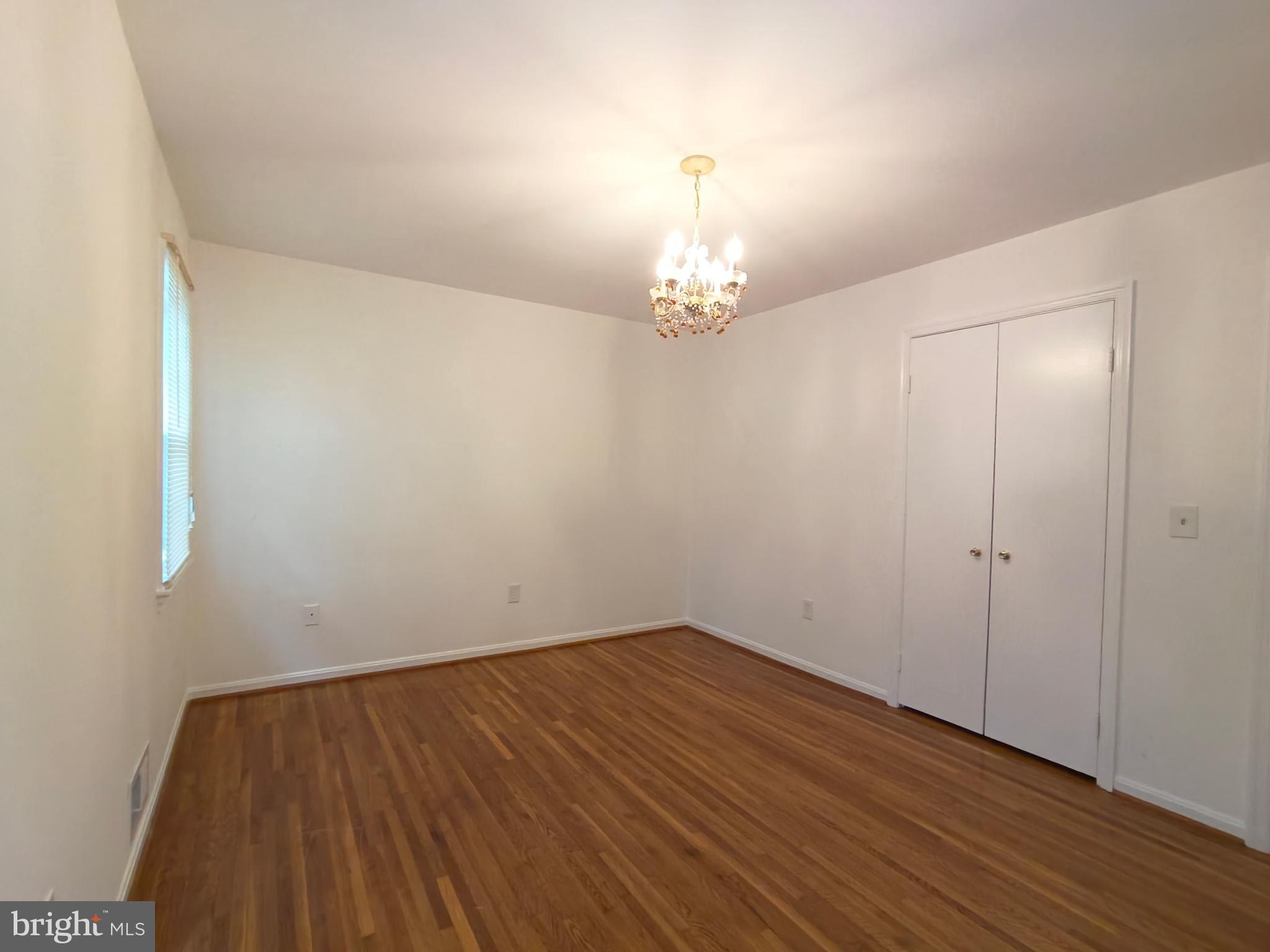 8835 Tuckerman Lane Potomac, MD 20854 - Photo 39 of 46 a view of a room with wooden floor and chandelier