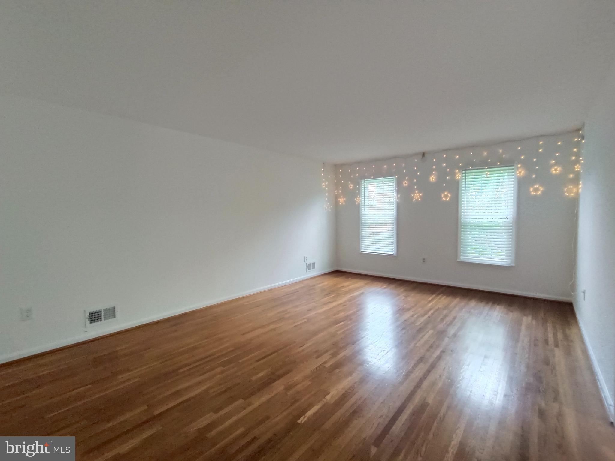 8835 Tuckerman Lane Potomac, MD 20854 - Photo 4 of 46 an empty room with wooden floor and windows