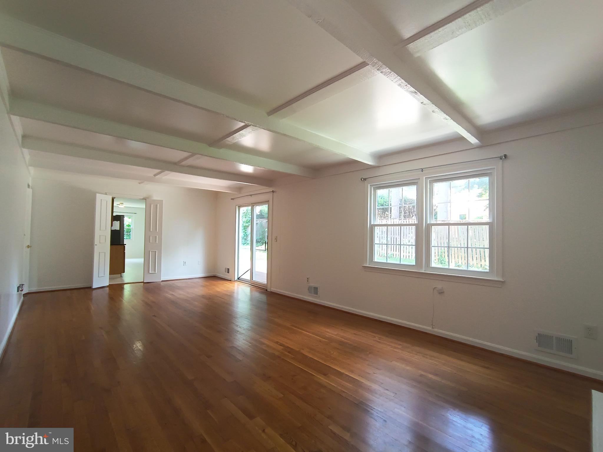 8835 Tuckerman Lane Potomac, MD 20854 - Photo 7 of 46 a view of an empty room with wooden floor and a window