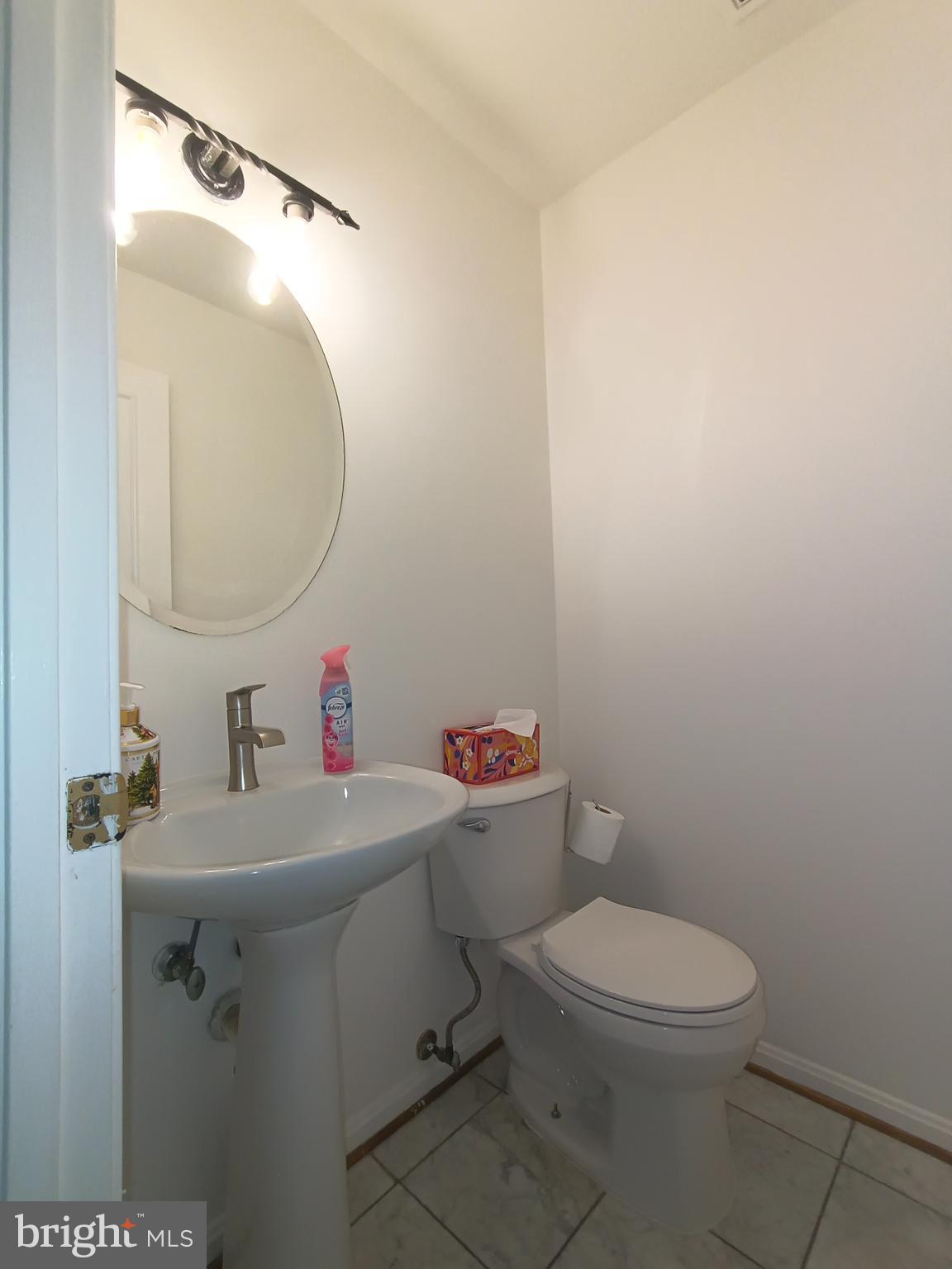 8835 Tuckerman Lane Potomac, MD 20854 - Photo 9 of 46 a white toilet sitting next to a bathroom sink