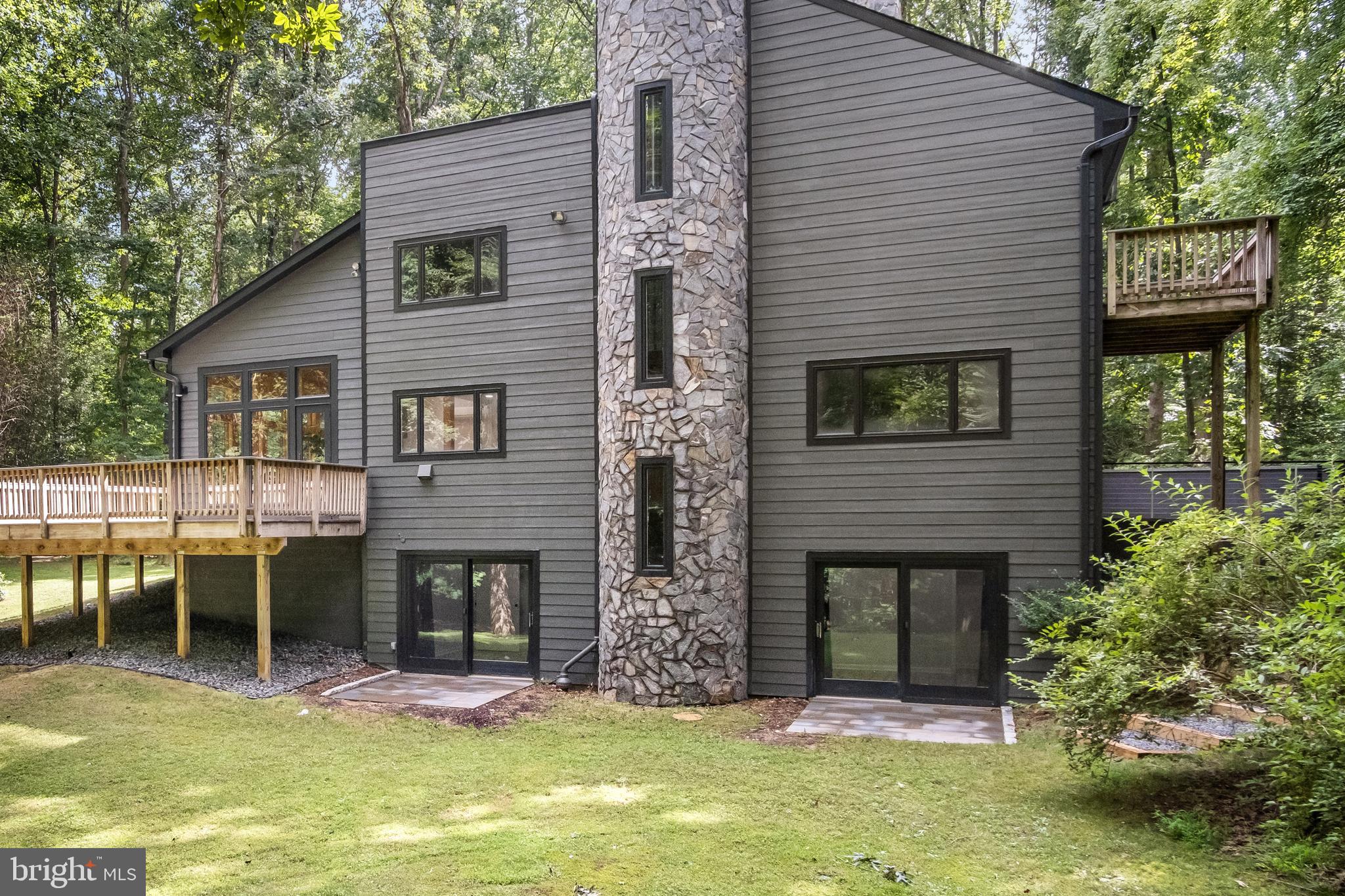 634 Springvale Road Great Falls, VA 22066 - Photo 12 of 67 a front view of a house with a yard garage and chairs