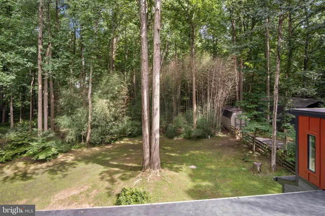 a view of an empty room with a fireplace and a window