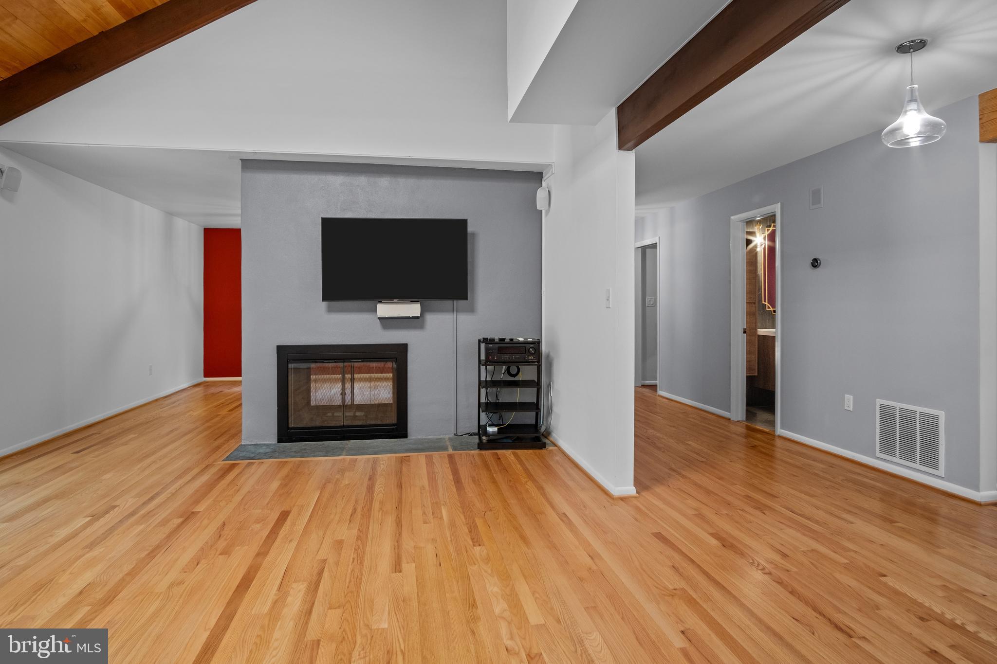 634 Springvale Road Great Falls, VA 22066 - Photo 35 of 67 a view of empty room with wooden floor and fireplace