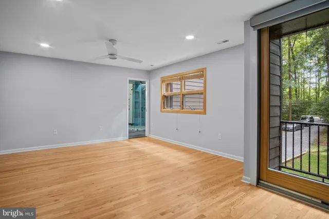 a view of an empty room and wooden floor