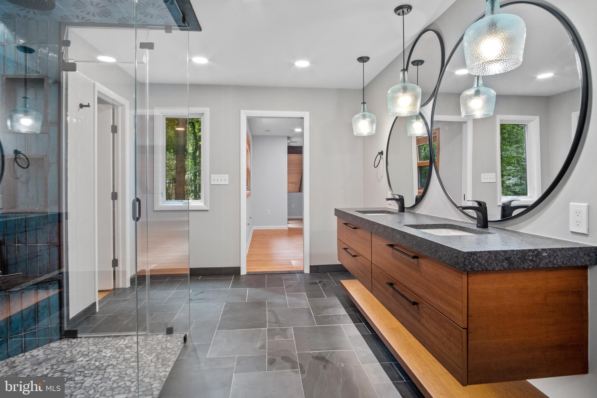634 Springvale Road Great Falls, VA 22066 - Photo 44 of 67 a spacious bathroom with a granite countertop sink a mirror and a shower