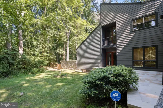 a front view of a house with a yard table and chairs