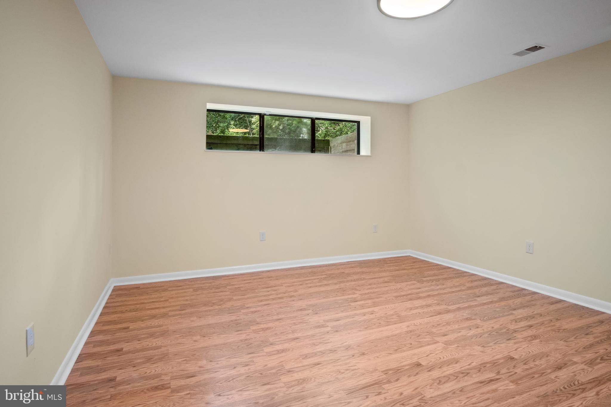 634 Springvale Road Great Falls, VA 22066 - Photo 63 of 67 a view of an empty room with wooden floor and a window