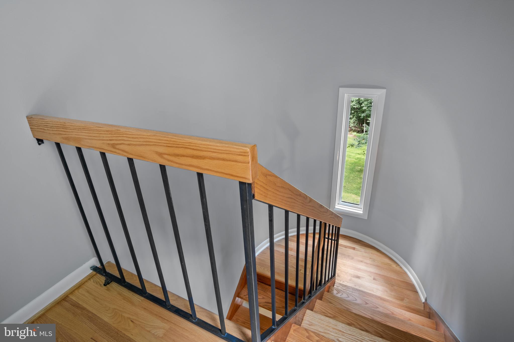 634 Springvale Road Great Falls, VA 22066 - Photo 67 of 67 a view of a hallway with wooden floor and stairs