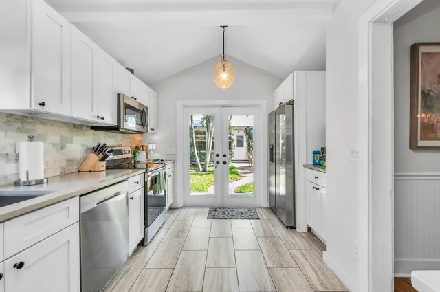 a kitchen with stainless steel appliances granite countertop a refrigerator and a sink