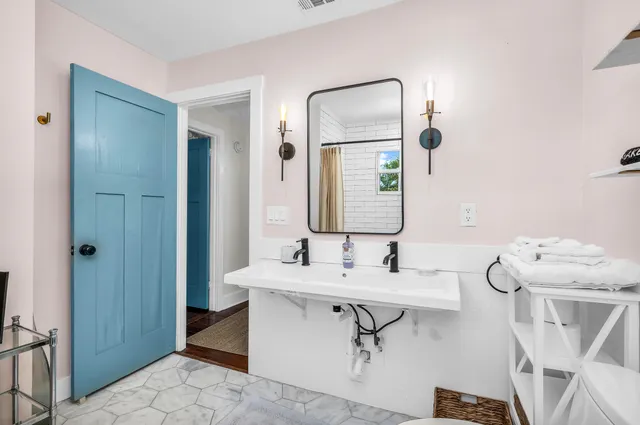 a bedroom with a bed mirror and a large window